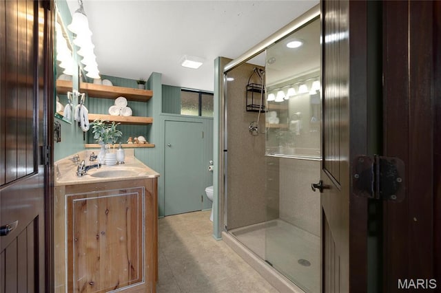 full bathroom featuring a shower stall, toilet, tile patterned floors, and vanity
