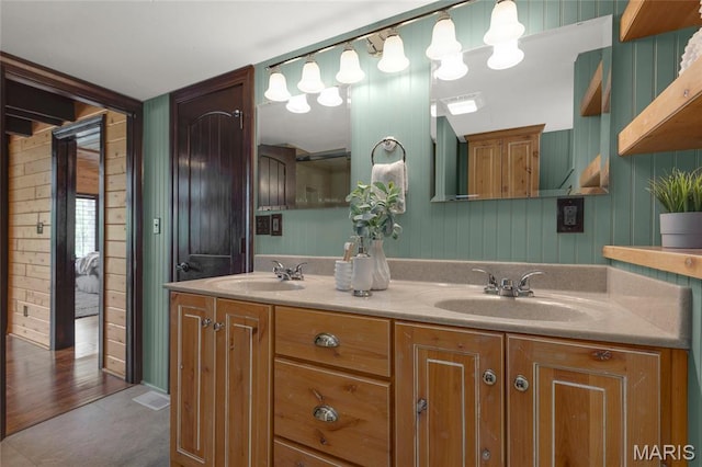 bathroom with double vanity and wooden walls