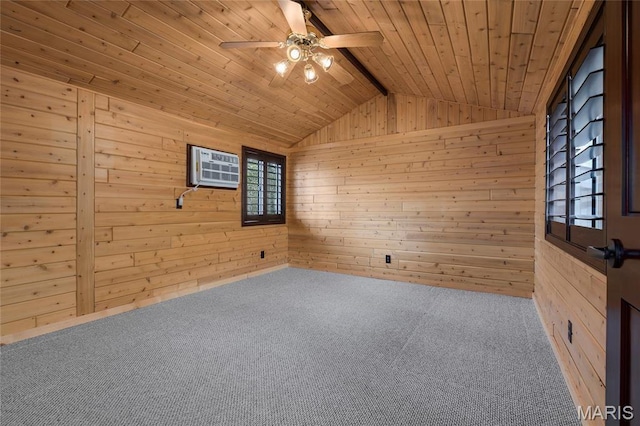 carpeted spare room featuring wood walls, ceiling fan, lofted ceiling, and wood ceiling