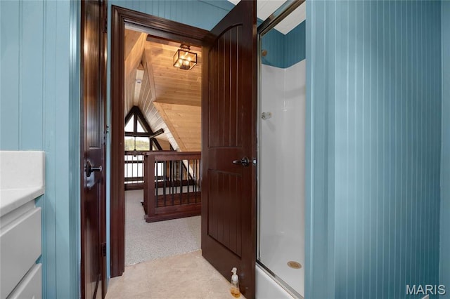 hall featuring wood walls