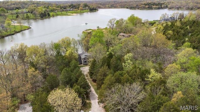 bird's eye view of a nearby body of water and a heavily wooded area