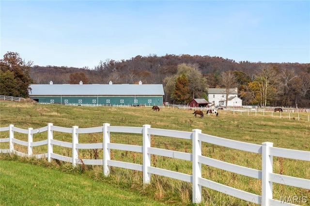 view of yard with a view of countryside and a forest view