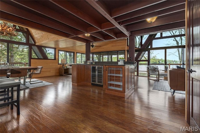 803 S Aspen Point Dr, Innsbrook, MO 63390 - dining room with beverage cooler, wooden walls, dark wood-style flooring, and a dry bar
