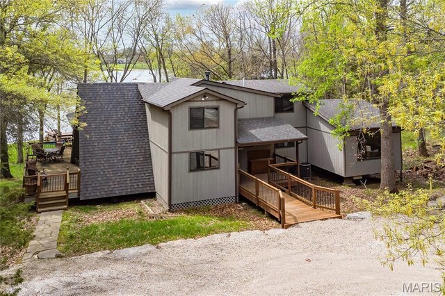 803 S Aspen Point Dr, Innsbrook, MO 63390 - view of front of home featuring a shingled roof, a wooden deck, and central air condition unit