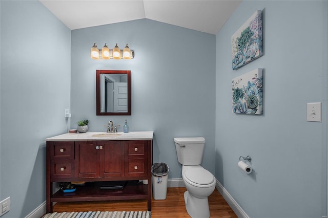 4650 Demaree St, House Springs, MO 63051 - bathroom featuring wood finished floors, baseboards, vanity, toilet, and vaulted ceiling