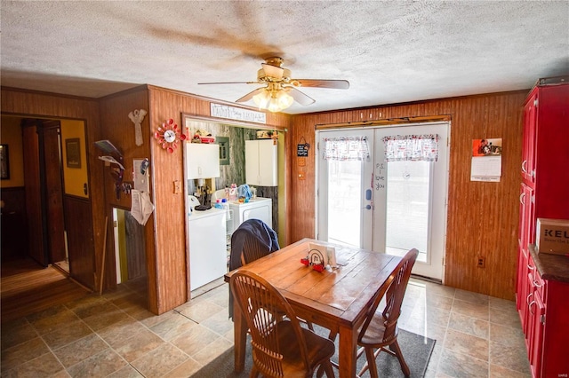 239 Olive St, Rockbridge, IL 62081 - dining space featuring washing machine and dryer, wood walls, french doors, ceiling fan, and a textured ceiling