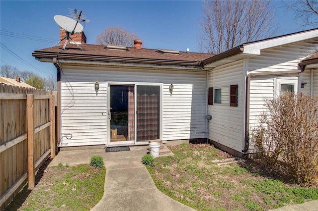 239 Olive St, Rockbridge, IL 62081 - back of house with fence, a shingled roof, and a chimney