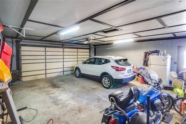 239 Olive St, Rockbridge, IL 62081 - garage with freestanding refrigerator and a garage door opener