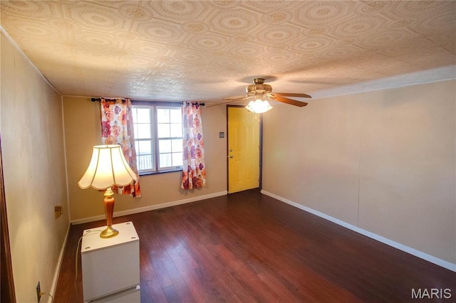 239 Olive St, Rockbridge, IL 62081 - spare room featuring dark wood-style flooring, ceiling fan, an ornate ceiling, and baseboards