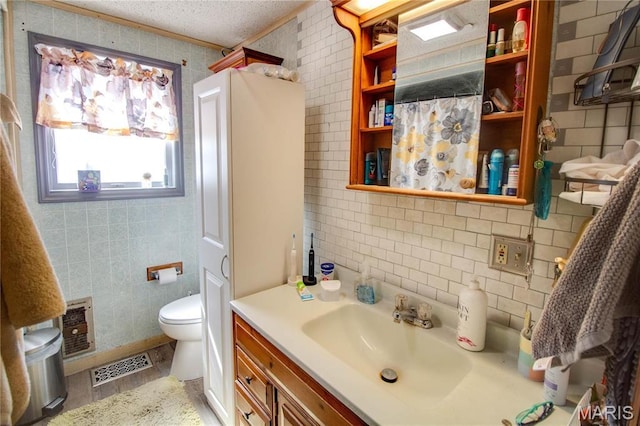 239 Olive St, Rockbridge, IL 62081 - bathroom with vanity, toilet, tile walls, decorative backsplash, and a textured ceiling