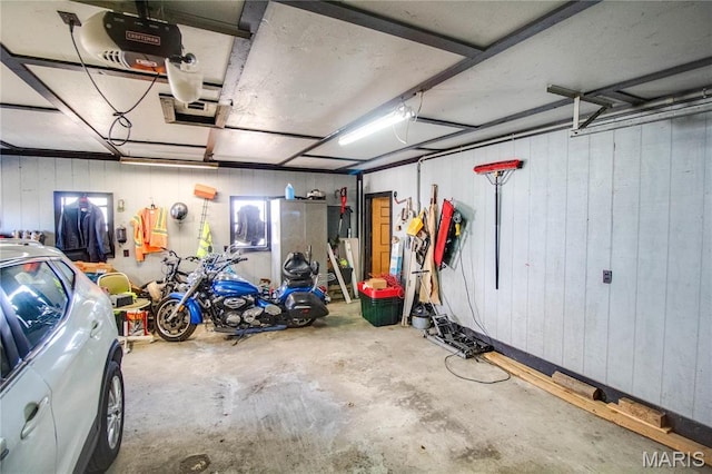 239 Olive St, Rockbridge, IL 62081 - garage with wood walls and a garage door opener