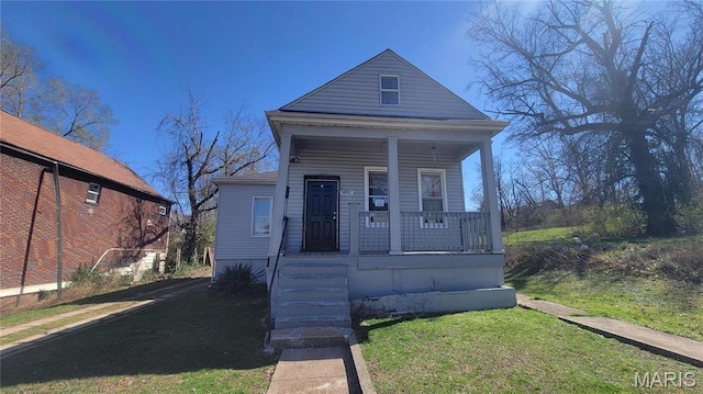 5052 Plover Ave, Saint Louis, MO 63120 - view of front of house with a porch and a front yard