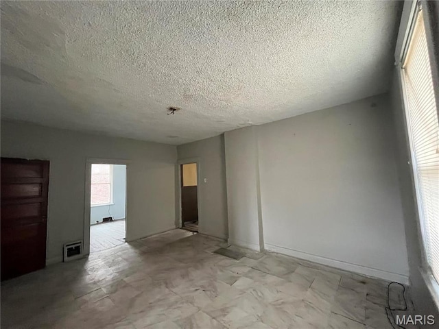5052 Plover Ave, Saint Louis, MO 63120 - spare room featuring a textured ceiling