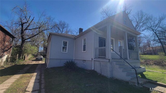 5052 Plover Ave, Saint Louis, MO 63120 - view of front of property with a porch and a chimney