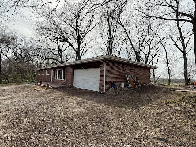 1227 Teson Rd, Hazelwood, MO 63042 - view of property exterior featuring brick siding and an attached garage