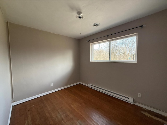 1227 Teson Rd, Hazelwood, MO 63042 - spare room featuring a baseboard radiator, wood-type flooring, and baseboards
