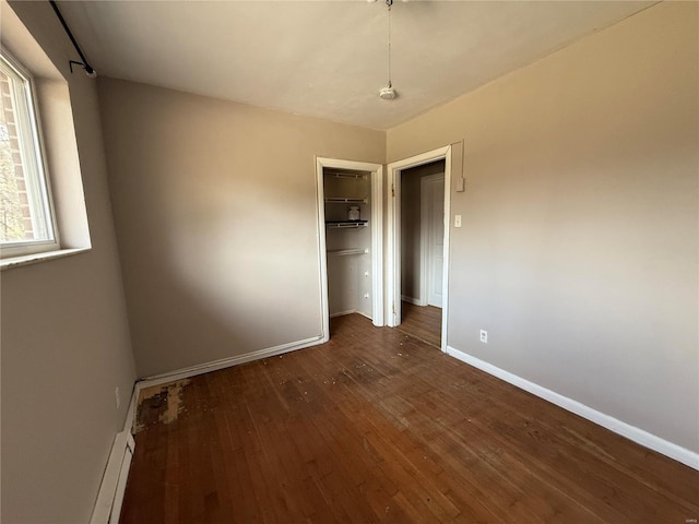 1227 Teson Rd, Hazelwood, MO 63042 - unfurnished bedroom with dark wood-style flooring, baseboards, and a closet