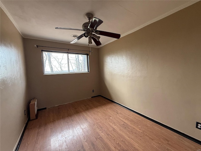 1227 Teson Rd, Hazelwood, MO 63042 - spare room featuring light wood-style floors, ornamental molding, ceiling fan, and baseboards