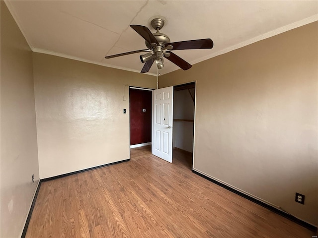 1227 Teson Rd, Hazelwood, MO 63042 - unfurnished bedroom with wood finished floors, baseboards, a closet, ornamental molding, and a ceiling fan