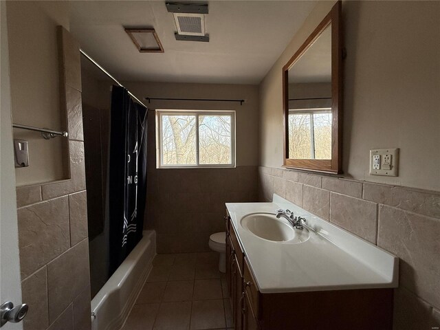 1227 Teson Rd, Hazelwood, MO 63042 - full bath featuring tile walls, tile patterned flooring, toilet, vanity, and wainscoting