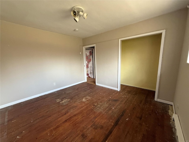 1227 Teson Rd, Hazelwood, MO 63042 - unfurnished bedroom featuring wood-type flooring, baseboards, a closet, and baseboard heating