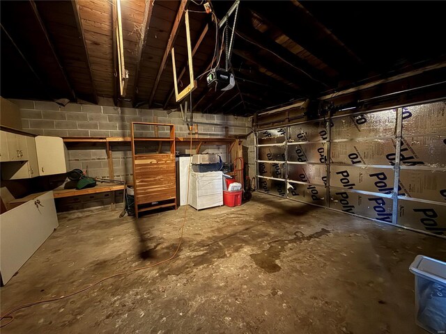1227 Teson Rd, Hazelwood, MO 63042 - garage featuring concrete block wall and a garage door opener