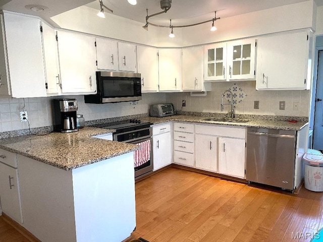 3921 Allenton Rd, Wildwood, MO 63069 - kitchen featuring appliances with stainless steel finishes, a sink, light wood-style floors, stone countertops, and tasteful backsplash
