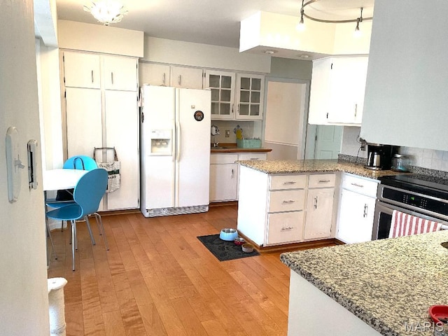 3921 Allenton Rd, Wildwood, MO 63069 - kitchen featuring white fridge with ice dispenser, stainless steel oven, white cabinetry, and light wood-type flooring