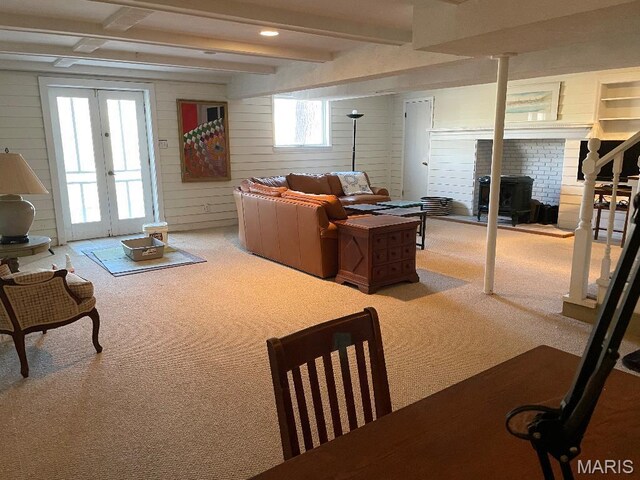 3921 Allenton Rd, Wildwood, MO 63069 - living room featuring carpet flooring, a wood stove, beam ceiling, wooden walls, and french doors