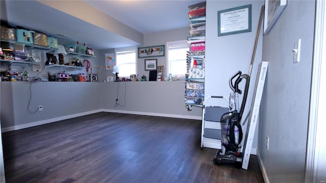 miscellaneous room featuring dark wood finished floors and baseboards