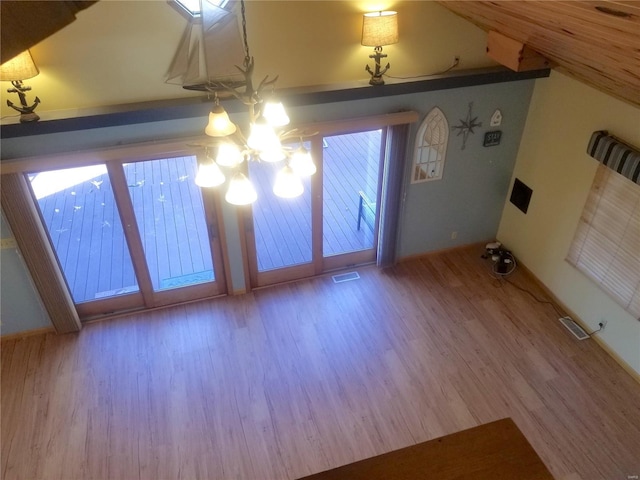 8774 E Chinquapin Ave E, Effingham, IL 62401 - interior space featuring wood finished floors, a chandelier, baseboards, and vaulted ceiling