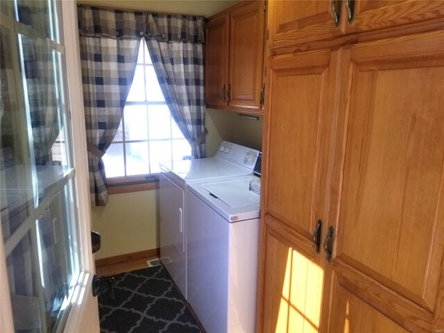 8774 E Chinquapin Ave E, Effingham, IL 62401 - washroom featuring separate washer and dryer, cabinet space, and baseboards