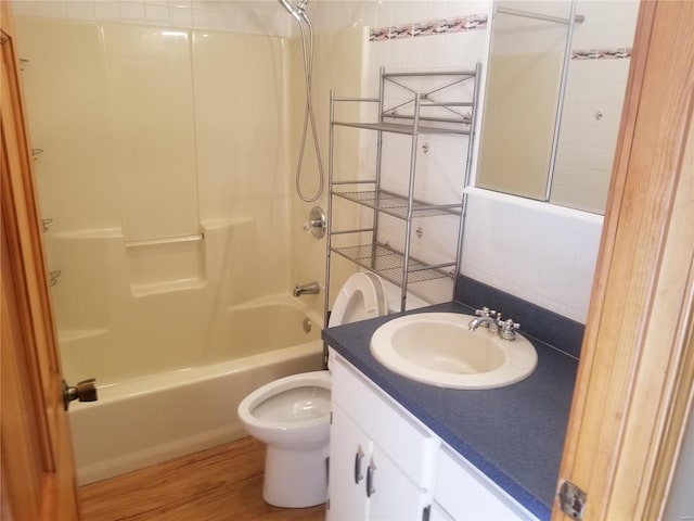 8774 E Chinquapin Ave E, Effingham, IL 62401 - bathroom with  shower combination, vanity, wood finished floors, toilet, and decorative backsplash