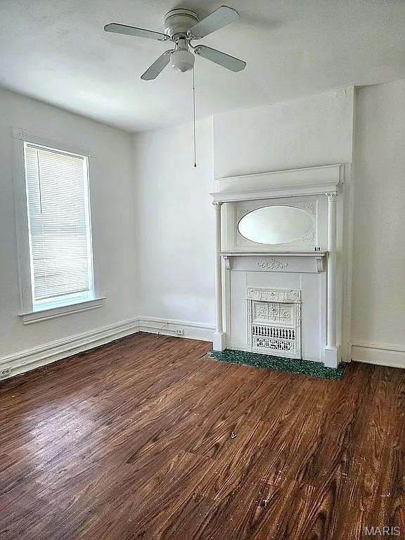 5244 Theodosia Ave, Saint Louis, MO 63113 - unfurnished living room featuring wood finished floors, a ceiling fan, and baseboards