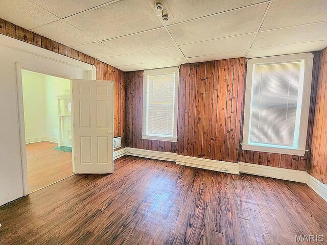 5244 Theodosia Ave, Saint Louis, MO 63113 - spare room with wood finished floors, baseboards, and wooden walls