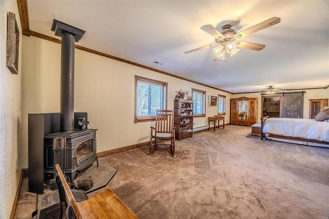 20677 Bend Rd, Crocker, MO 65452 - carpeted bedroom featuring a wood stove, crown molding, baseboards, and baseboard heating