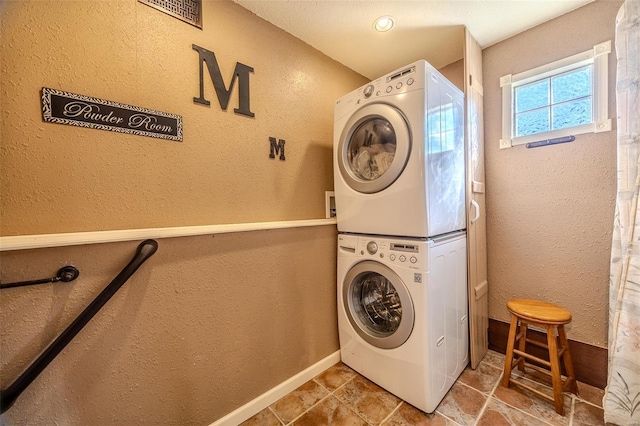 20677 Bend Rd, Crocker, MO 65452 - laundry room with stacked washer / drying machine, a textured wall, and baseboards
