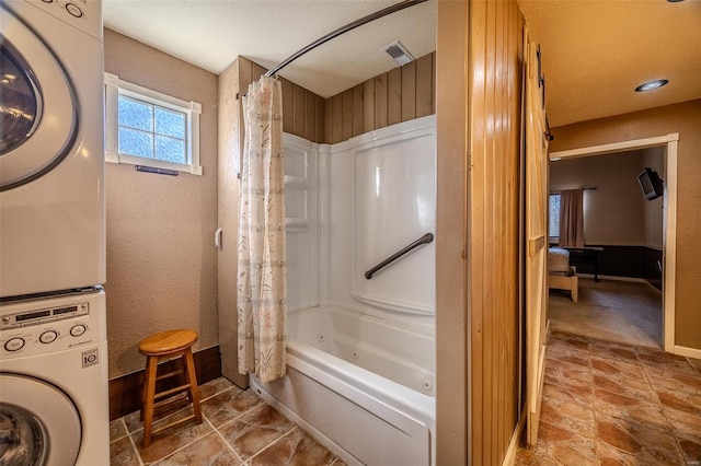 20677 Bend Rd, Crocker, MO 65452 - full bath with estacked washer and dryer, shower / tub combo, and stone finish flooring