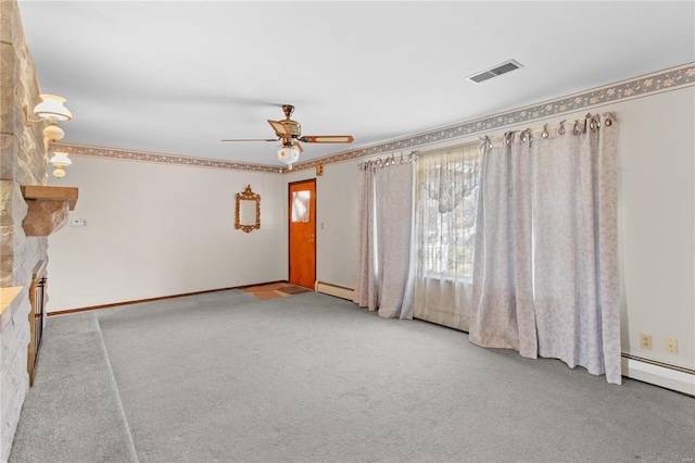 carpeted empty room with a ceiling fan and a baseboard heating unit