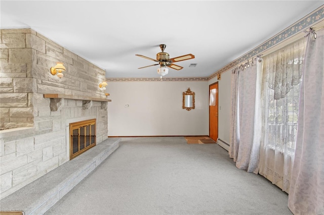 unfurnished living room featuring a ceiling fan, a baseboard heating unit, light carpet, a stone fireplace, and baseboards
