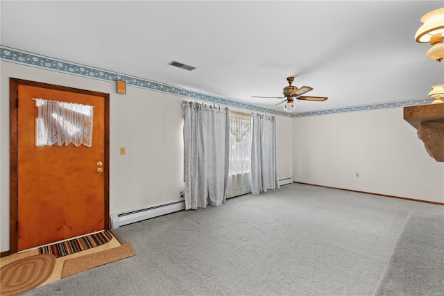 entryway featuring a baseboard heating unit, ceiling fan, and carpet