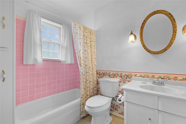 full bathroom featuring vanity, toilet, a wainscoted wall, and shower / bath combo with shower curtain