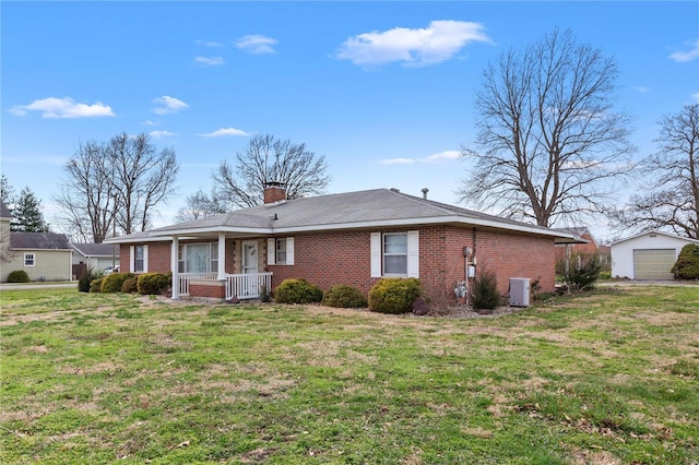 view of front of property featuring a porch, brick siding, a front lawn, and a chimney