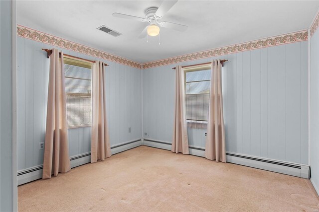 carpeted spare room featuring a ceiling fan