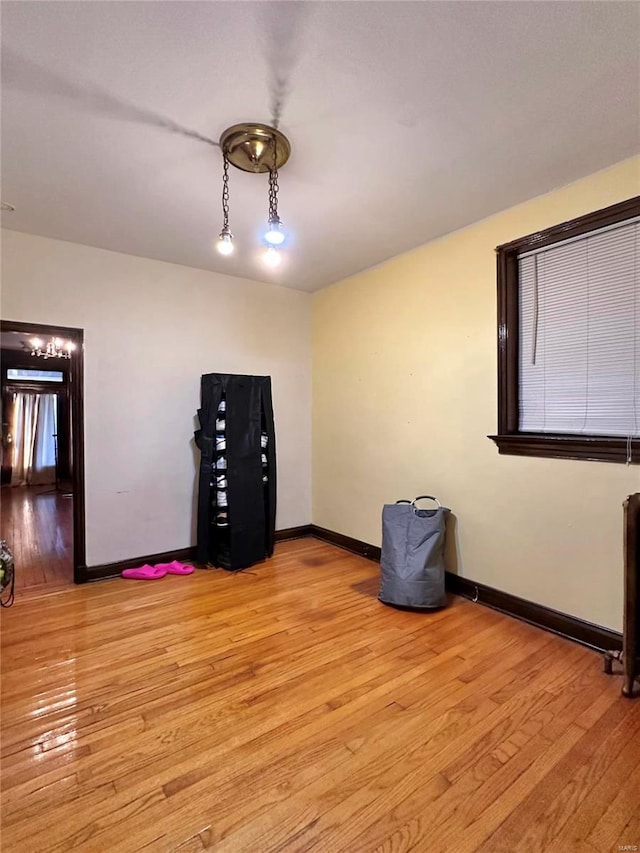 unfurnished room featuring light wood-type flooring and baseboards