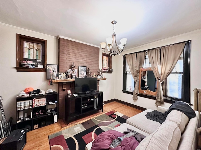 living area featuring a chandelier, wood finished floors, healthy amount of natural light, and ornamental molding