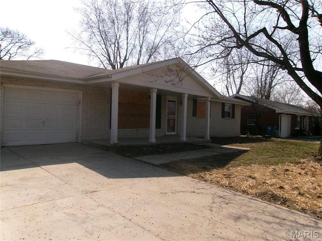 26 Victoria Dr, Pontoon Beach, IL 62040 - single story home featuring a garage, concrete driveway, brick siding, and a porch