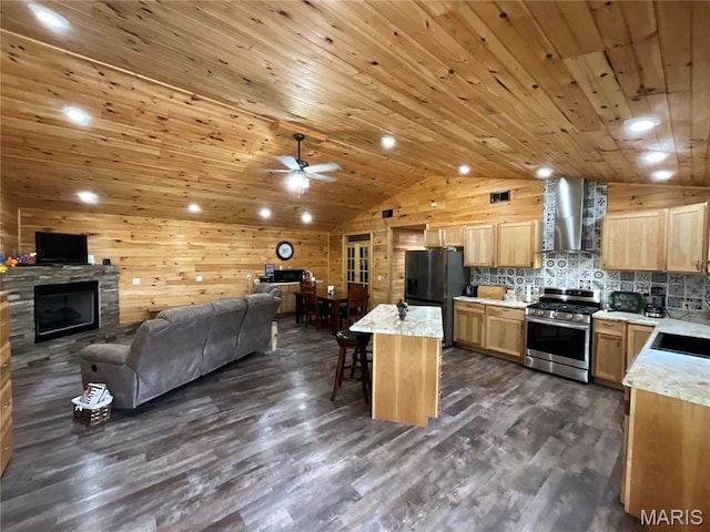 2887 County Road 5620, Willow Springs, MO 65789 - kitchen with stainless steel gas stove, black fridge with ice dispenser, wall chimney exhaust hood, lofted ceiling, and open floor plan