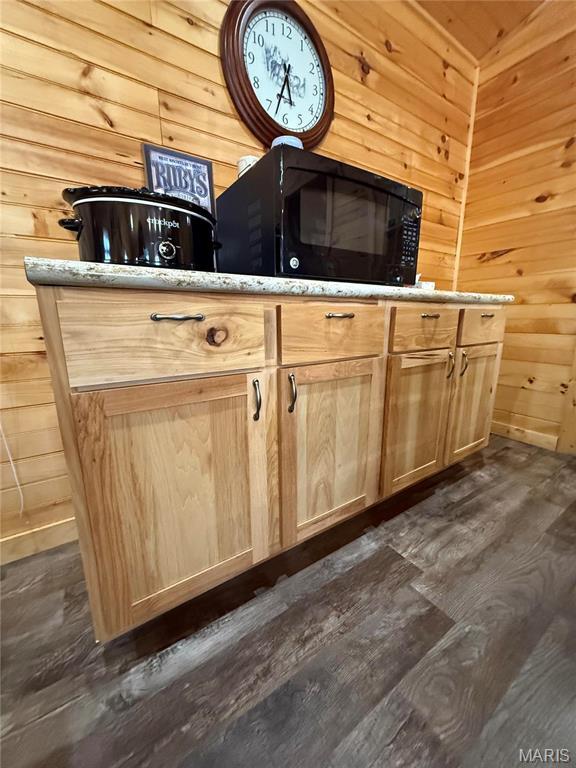 2887 County Road 5620, Willow Springs, MO 65789 - detailed view of black microwave, wood walls, and wood finished floors