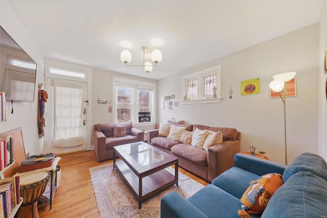 5044 Lindenwood Ave, Saint Louis, MO 63109 - living area with a chandelier and light wood-style floors